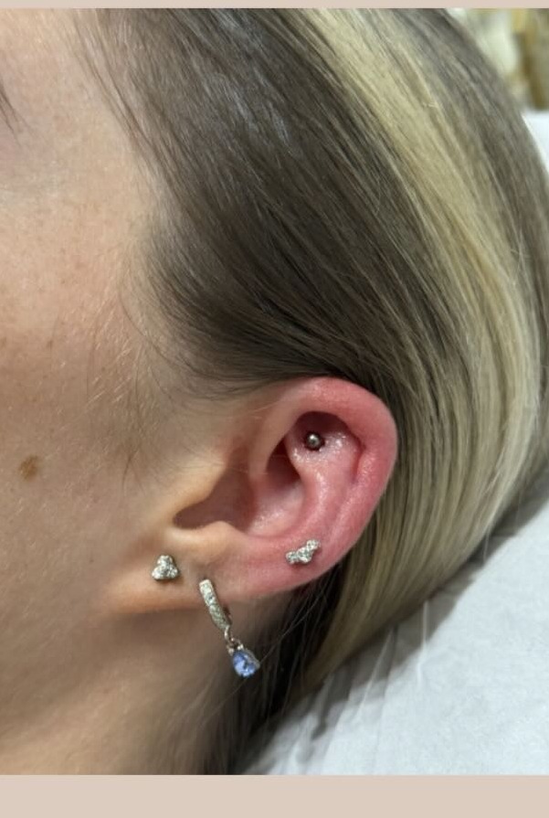 Flat ear piercing with a gold stud, alongside healed lobe and helix piercings, Precious Moments Beauty Clinic, Banstead