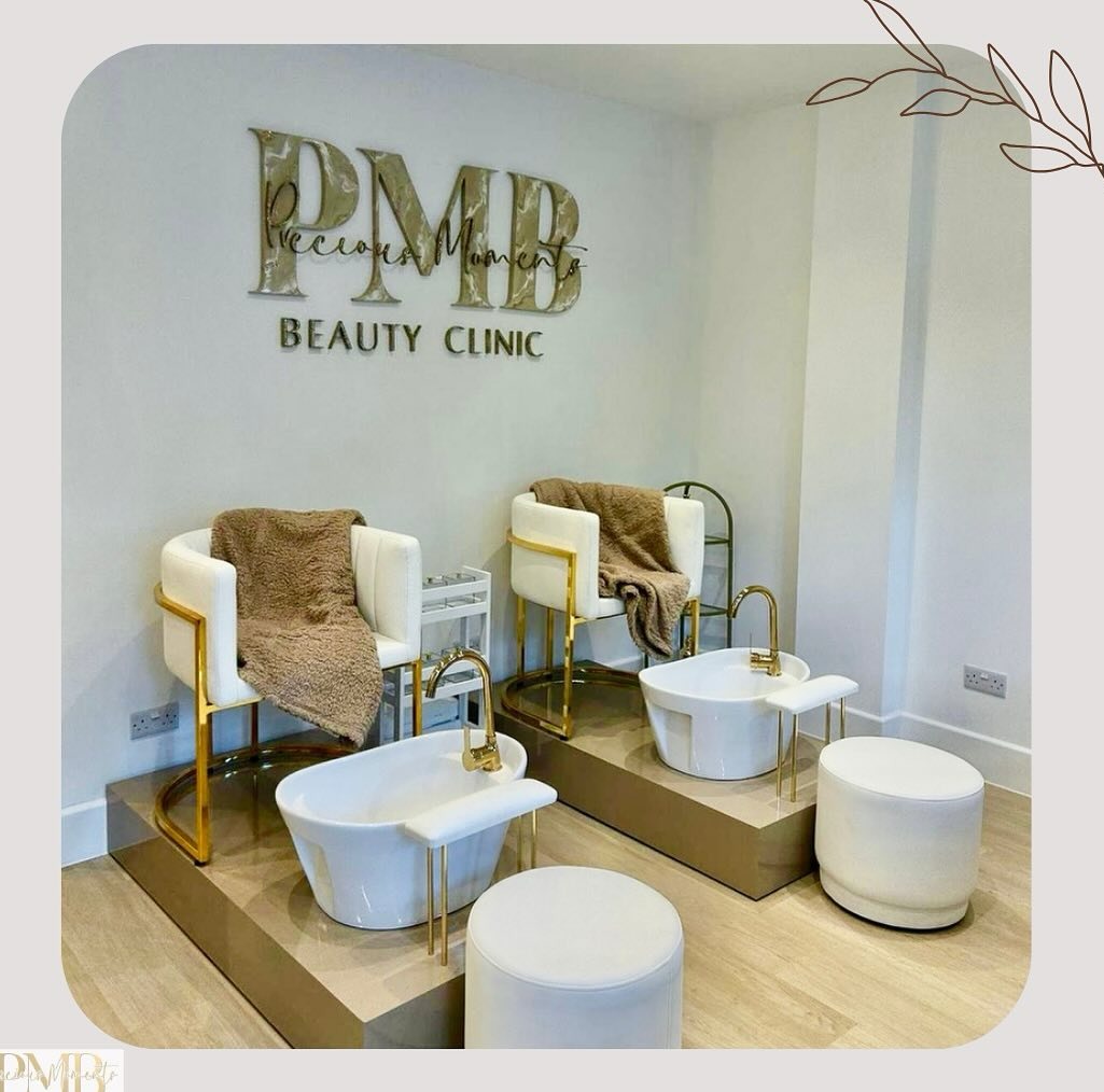 Pedicure lounge with white and gold basin chairs beneath the PMB signage at Precious Moments Beauty Clinic, Banstead