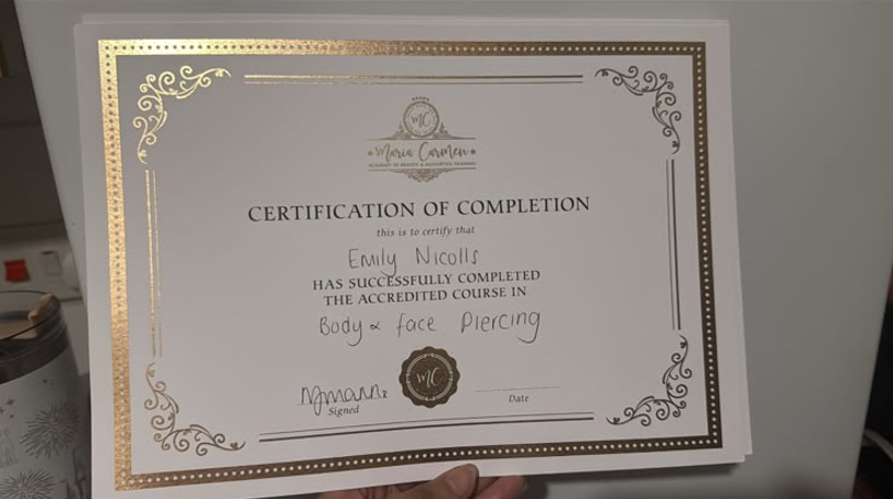 Certificate of completion, Body & Face Piercing, awarded to Emily Nicolls by Maria Carmen Academy of Beauty & Aesthetics Training