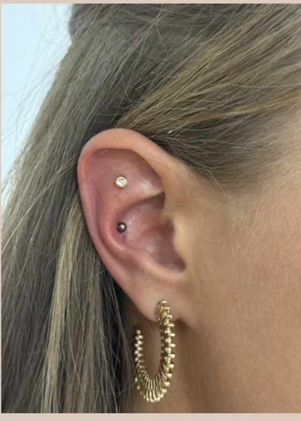 Conch ear piercing with a gold gem stud at Precious Moments Beauty Clinic, Banstead